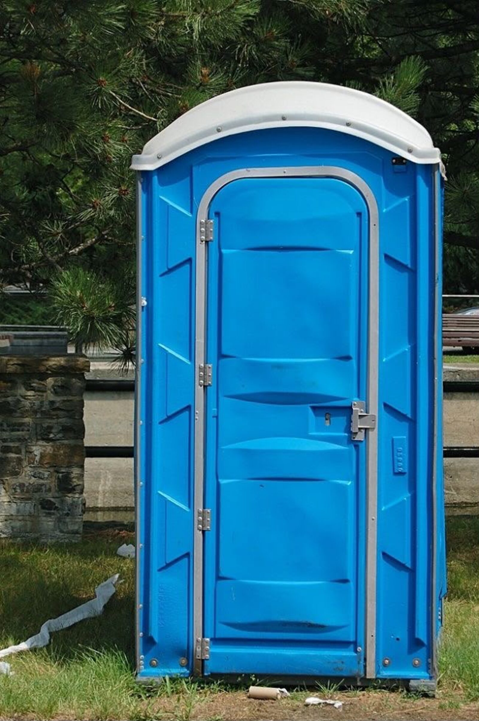 Construction crew taking a break near a portable toilet on site